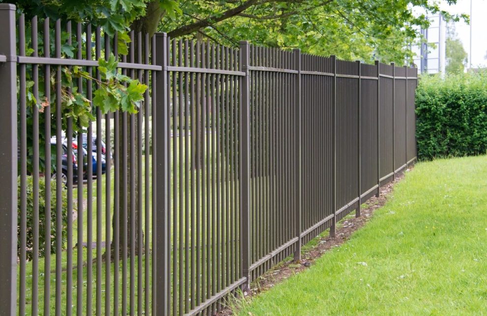 A fence that has some trees in the background