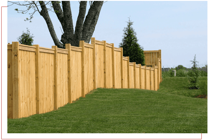 A wooden fence is shown with grass in the foreground.